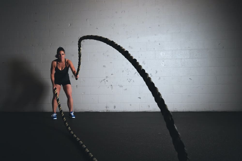 Woman working out at the gym with the best hairstyles for active women